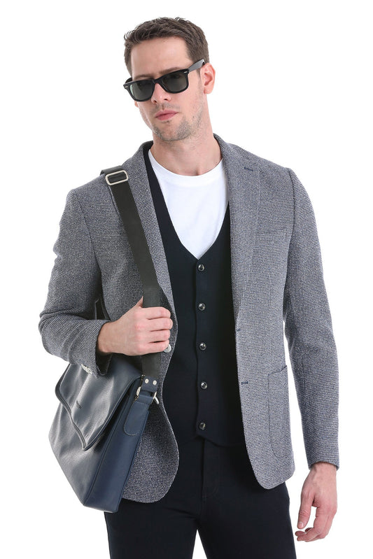 Gray textured blazer with black vest and white t-shirt underneath