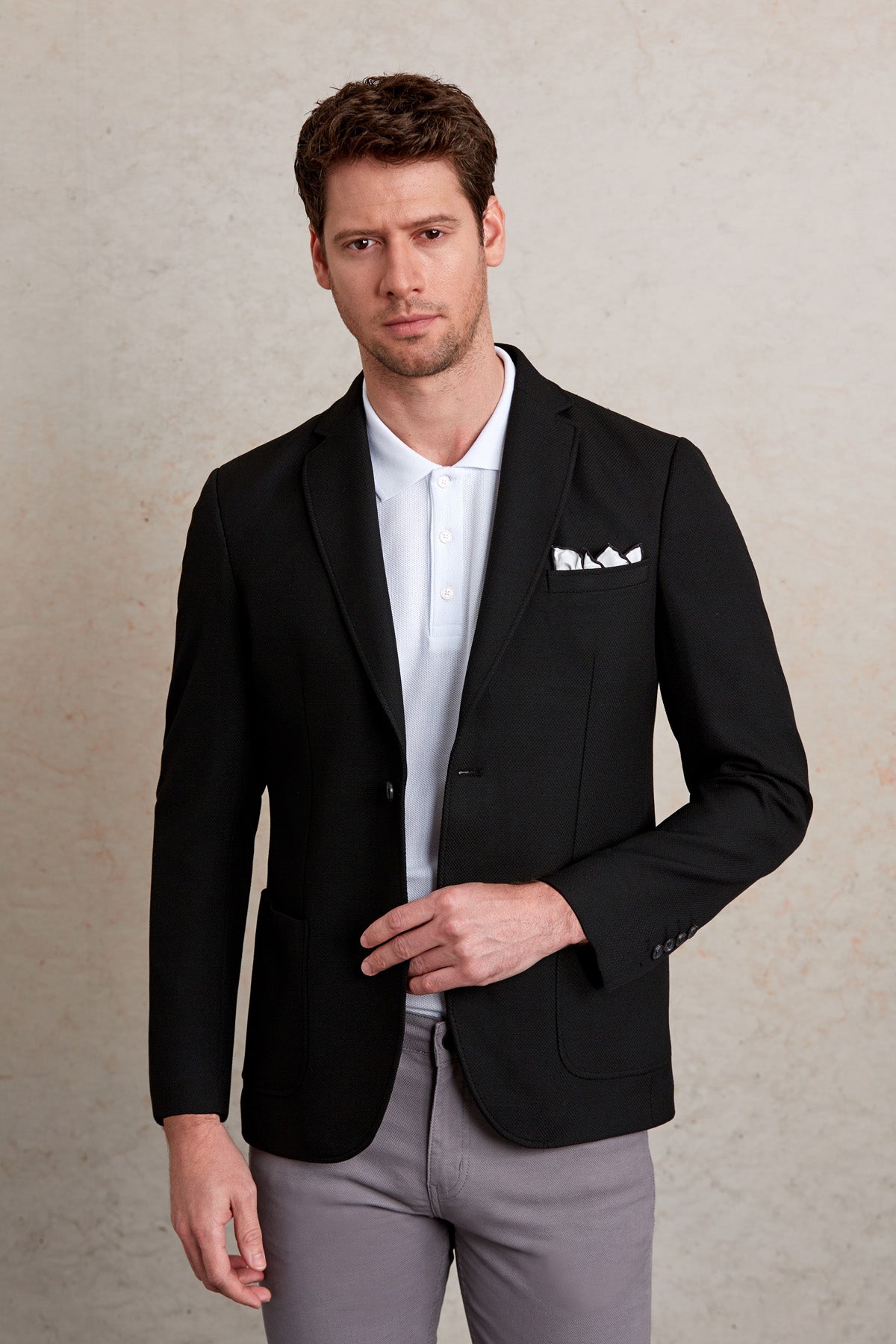 Black blazer with a sleek, tailored fit and subtle texture.