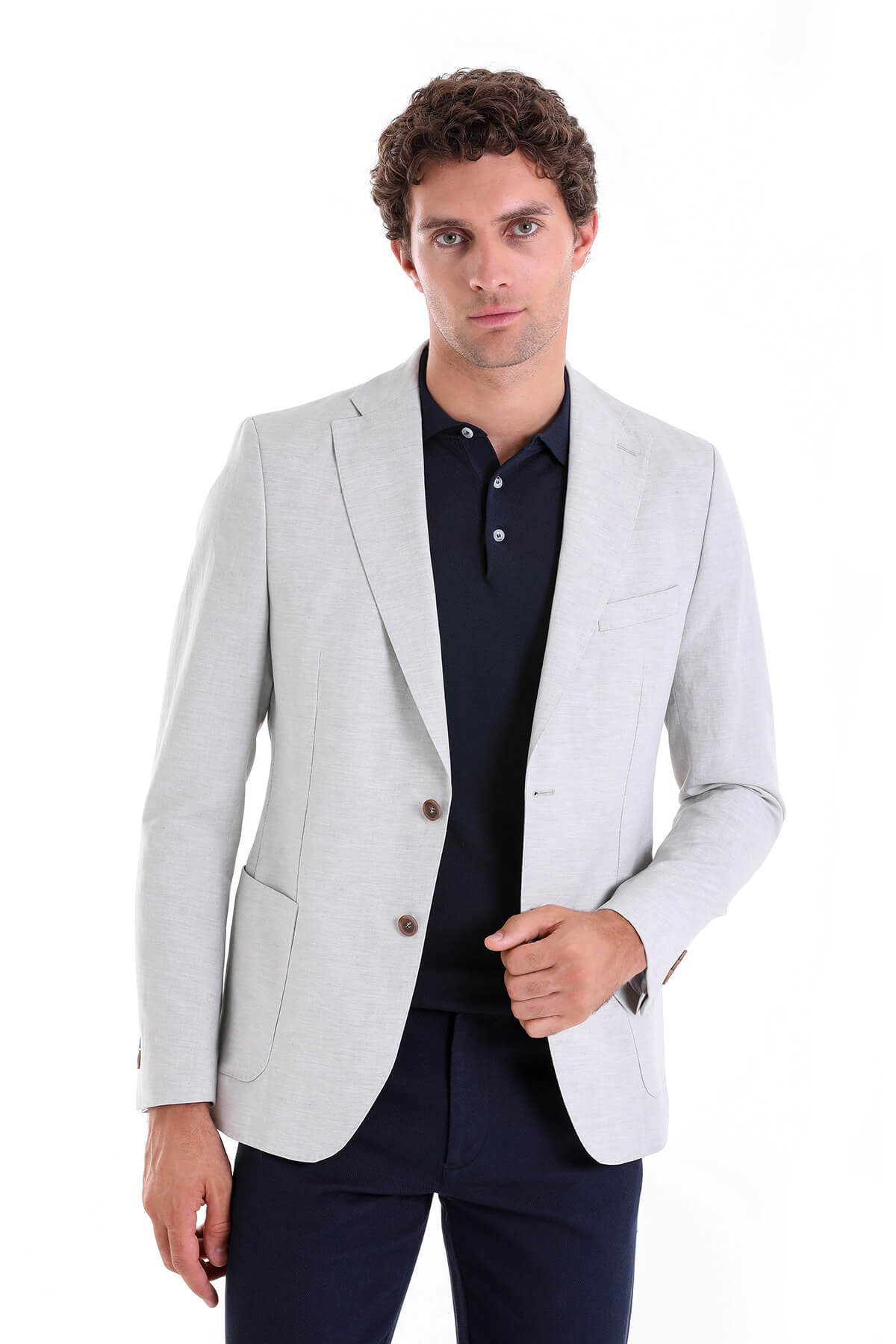 Light gray tailored blazer with subtle texture and matching brown buttons.