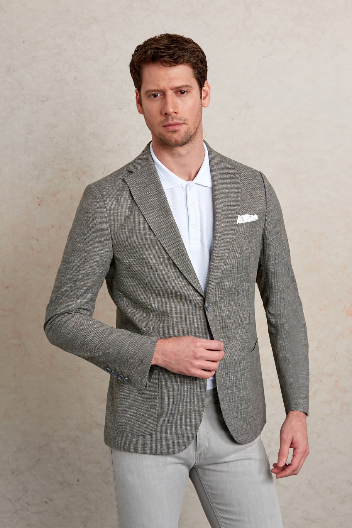 Gray textured blazer with a subtle herringbone pattern and a single-breasted design.