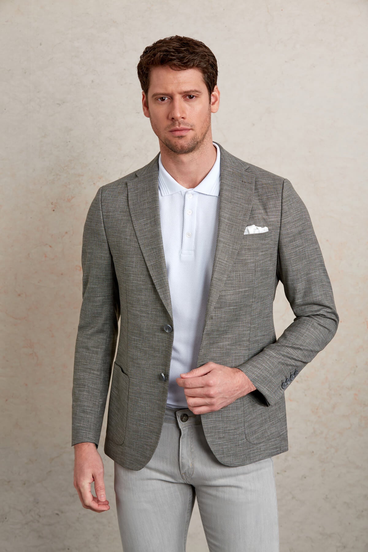Gray textured blazer with subtle pattern and structured shoulders.