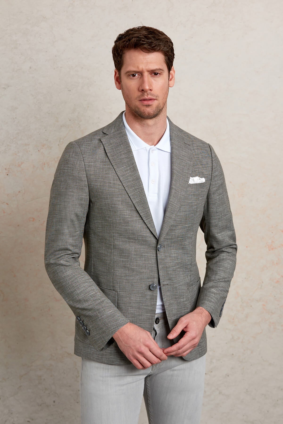 A tailored gray blazer with a subtle textured weave and two-button closure.