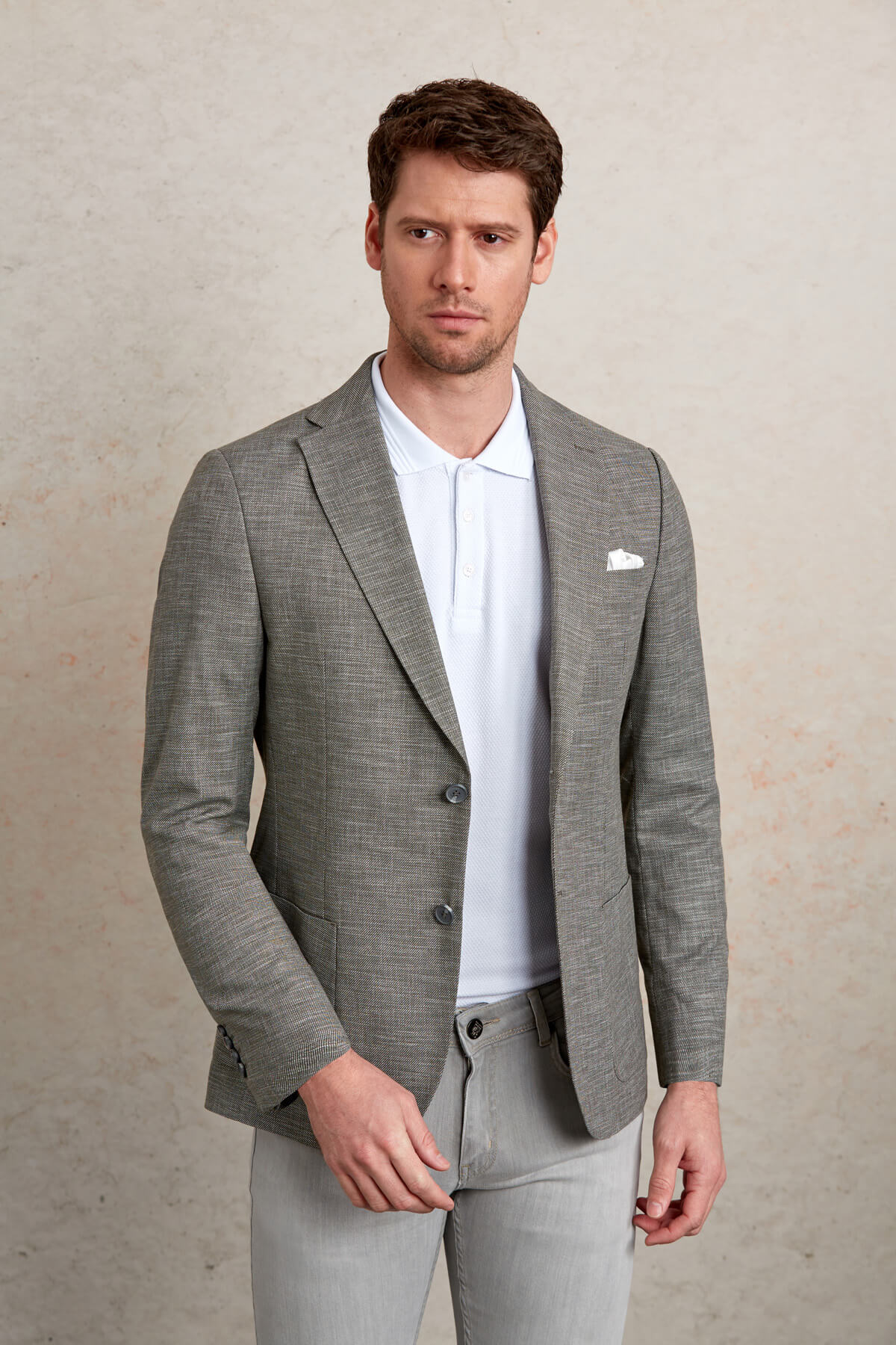 Gray textured blazer with subtle pattern and three-button closure.