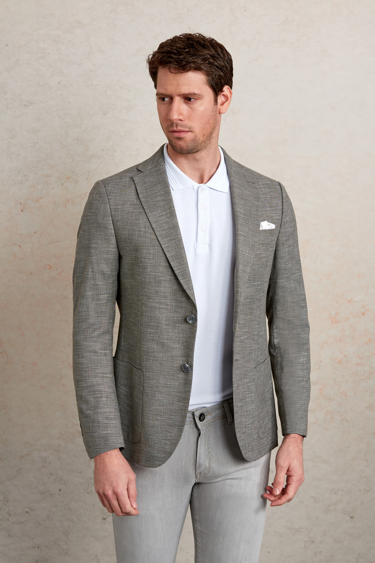 Gray textured blazer with subtle pattern and three-button closure.