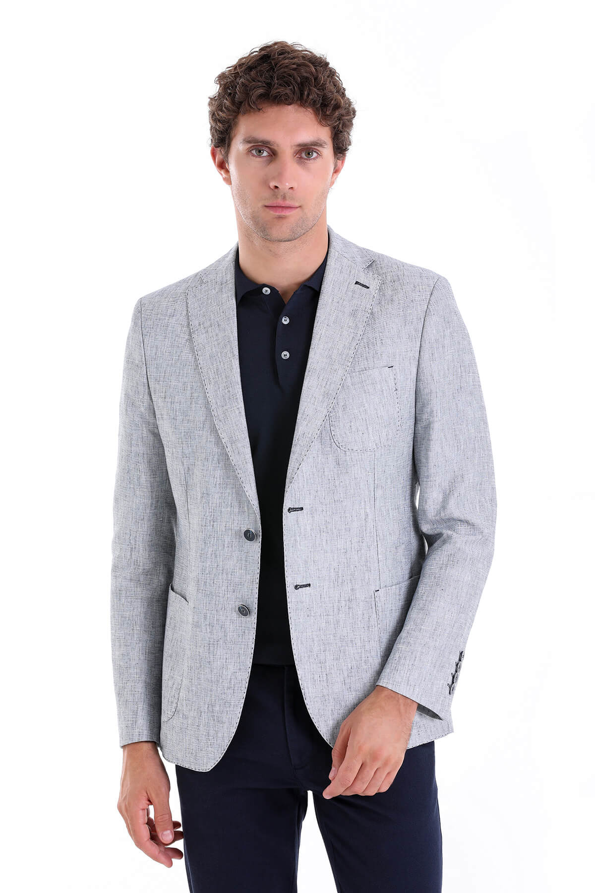Light gray textured blazer with subtle pattern and dark buttons.