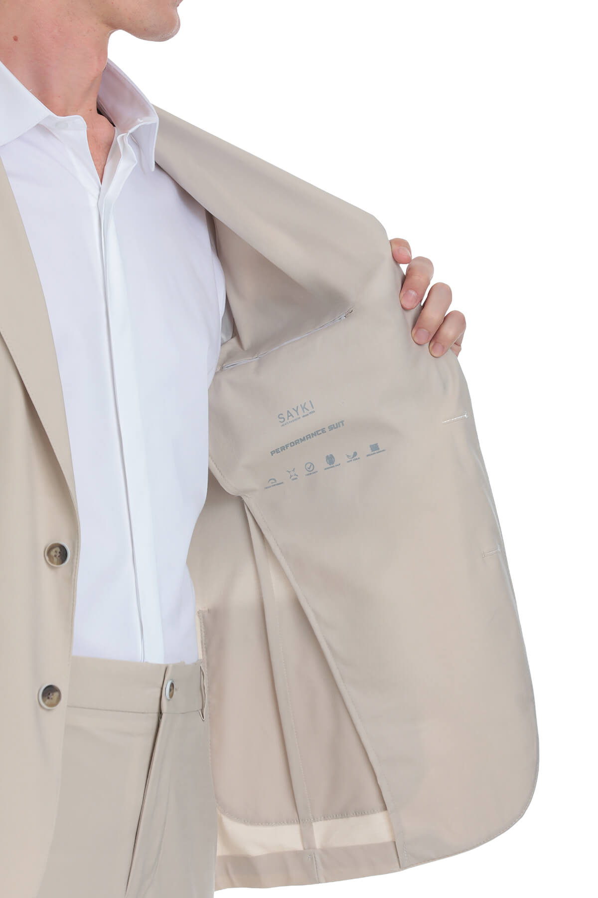 Beige skins performance suit jacket with subtle stitching and button details.