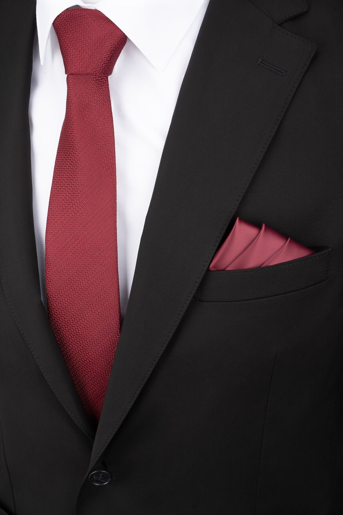 A rich burgundy textured silk tie paired with a matching pocket square.