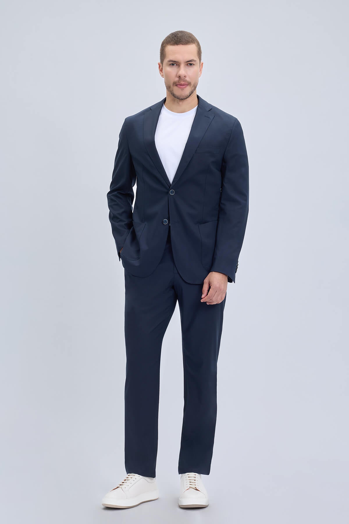 Navy blue slim fit notch lapel suit with lightweight fabric and subtle texture for casual modern wear