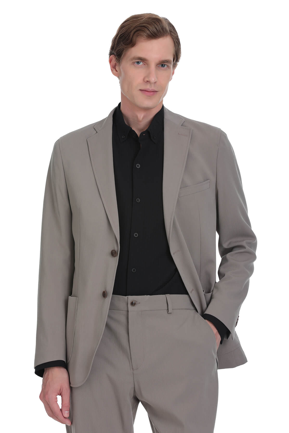 A tailored beige suit jacket with a sleek, modern cut and black inner lining.