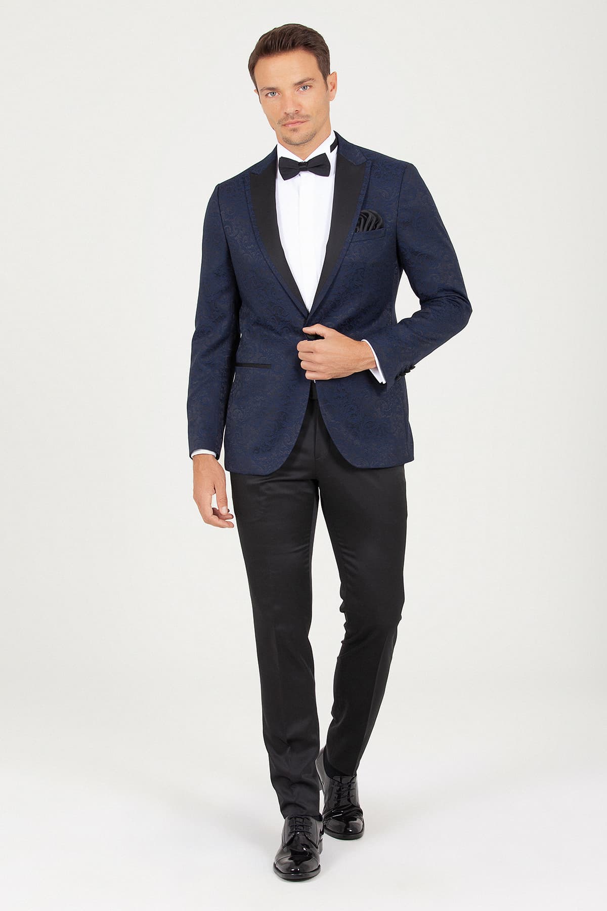 Navy blue tuxedo jacket with black satin lapels and a matching pocket square