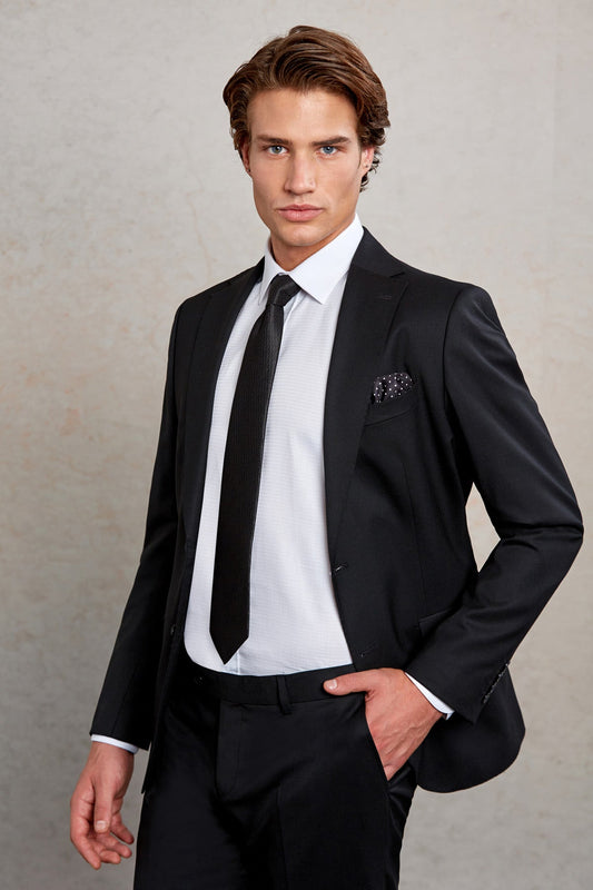 Black tailored suit jacket with subtle sheen and a patterned pocket square.