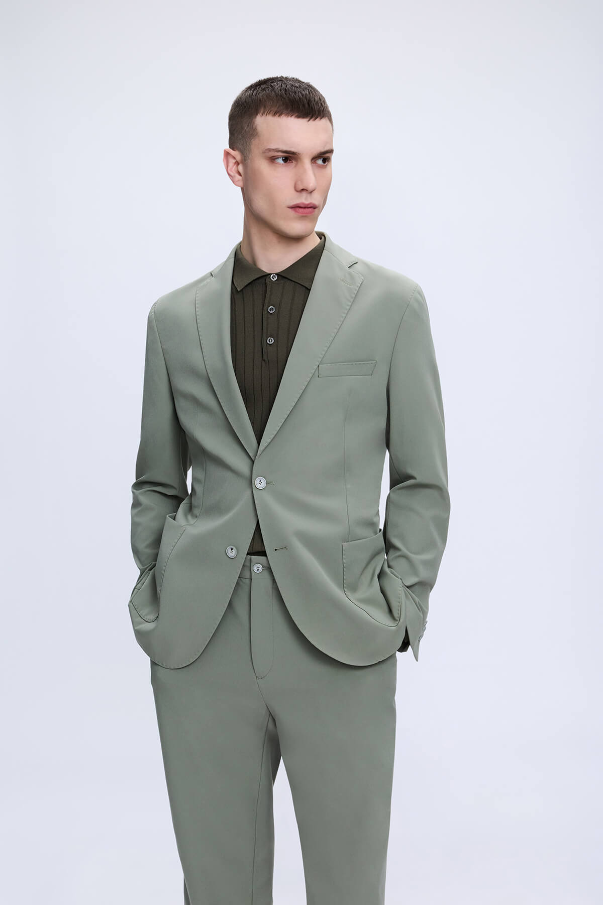 Slim fit notch lapel sage green tailored suit with modern cut and subtle texture perfect for casual wear