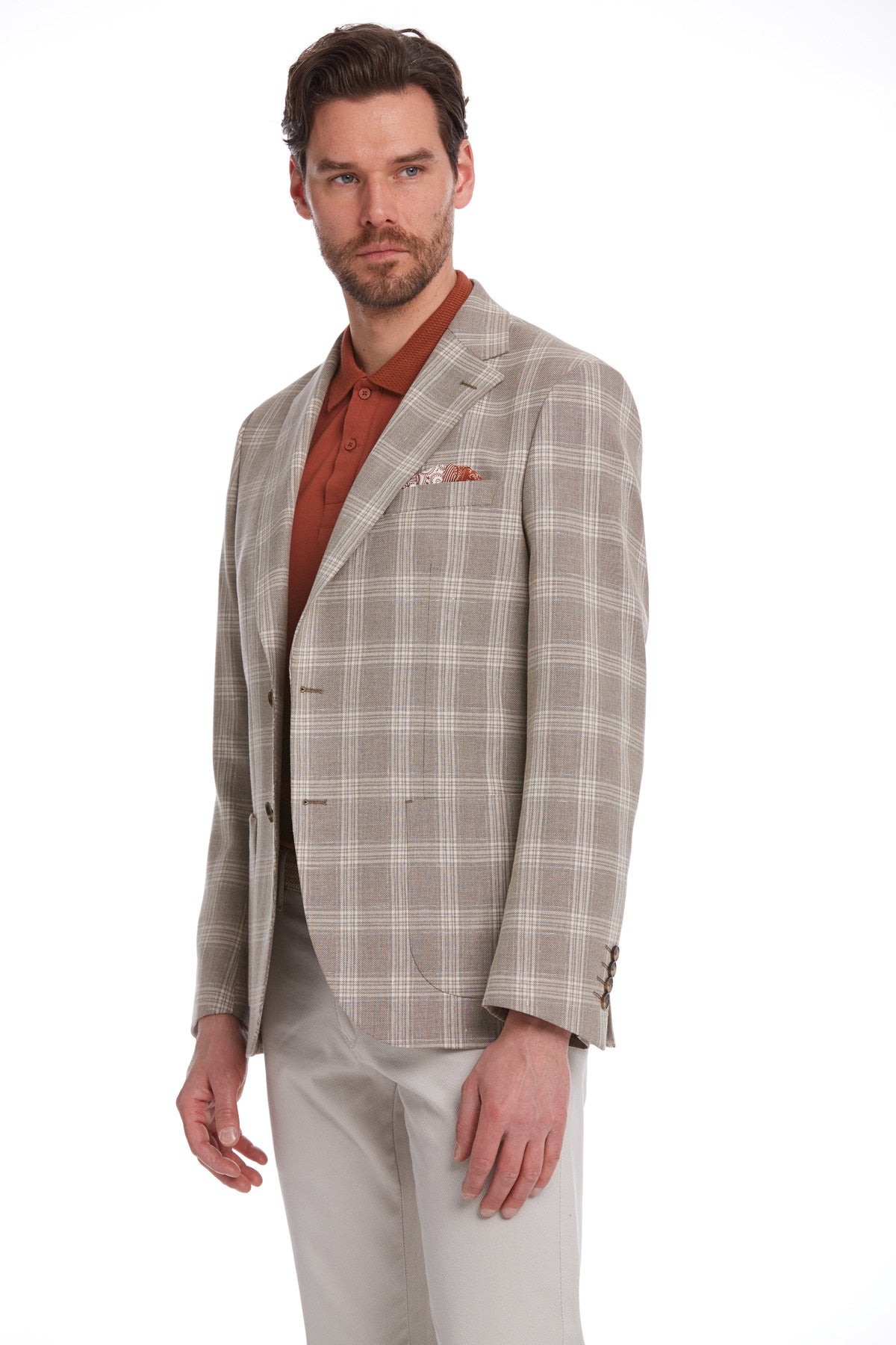 A men’s tailored blazer in a beige and white plaid pattern, featuring subtle texture and classic notched lapels.