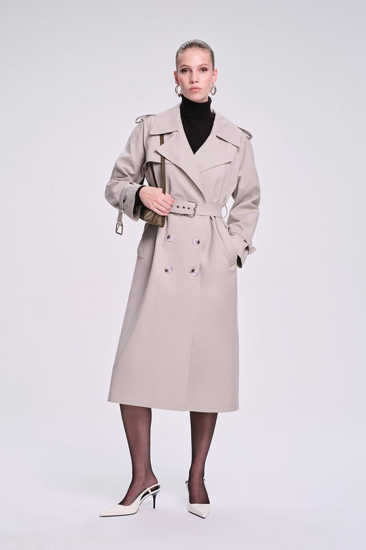 Beige trench coat with double-breasted front, belted waist, and structured shoulders.