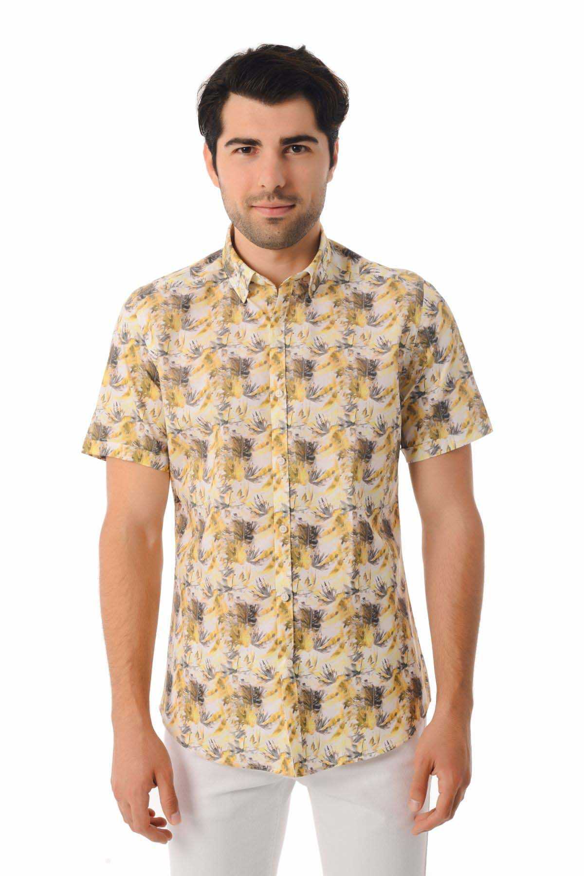 A men’s short-sleeved button-up shirt in a light beige base with a repeating pattern of yellow and dark gray tropical leaves.