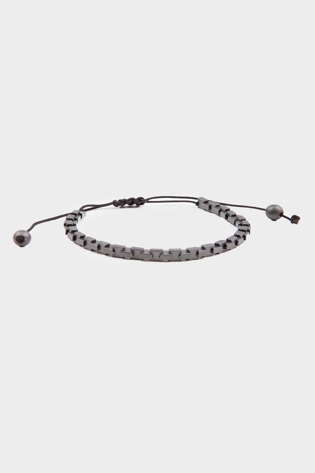 Black metal chain bracelet with spherical end beads and adjustable cord.