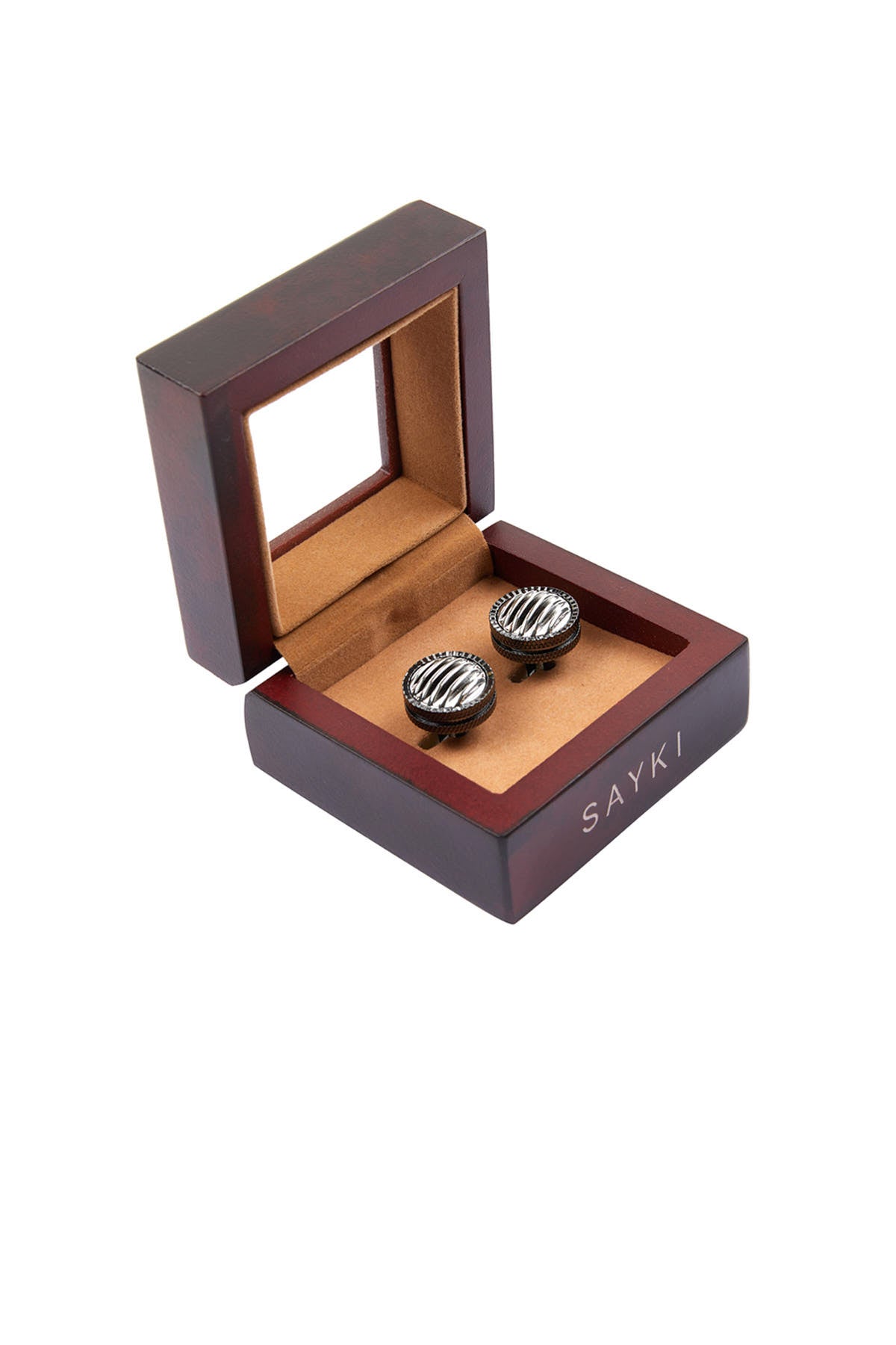 A pair of black, textured cufflinks with a striped pattern sit inside an open wooden box.