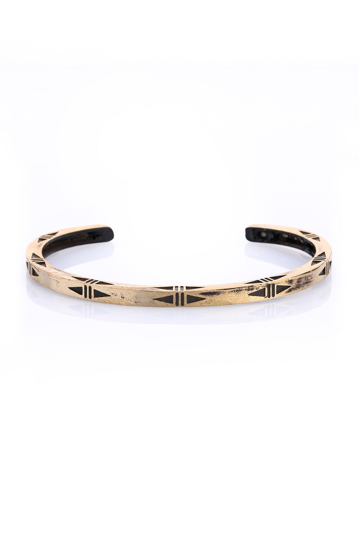 Gold-toned cuff bracelet with black geometric inlay patterns.