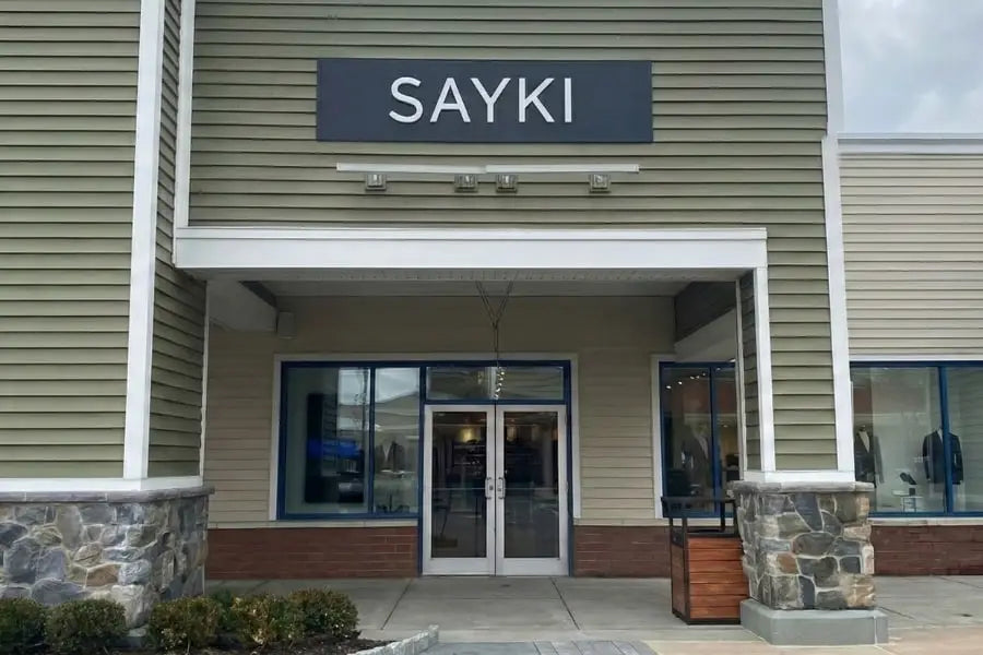 The sayki store sign at wrentham village premium outlets sells tuxedos starting at 199.90 in bold white letters