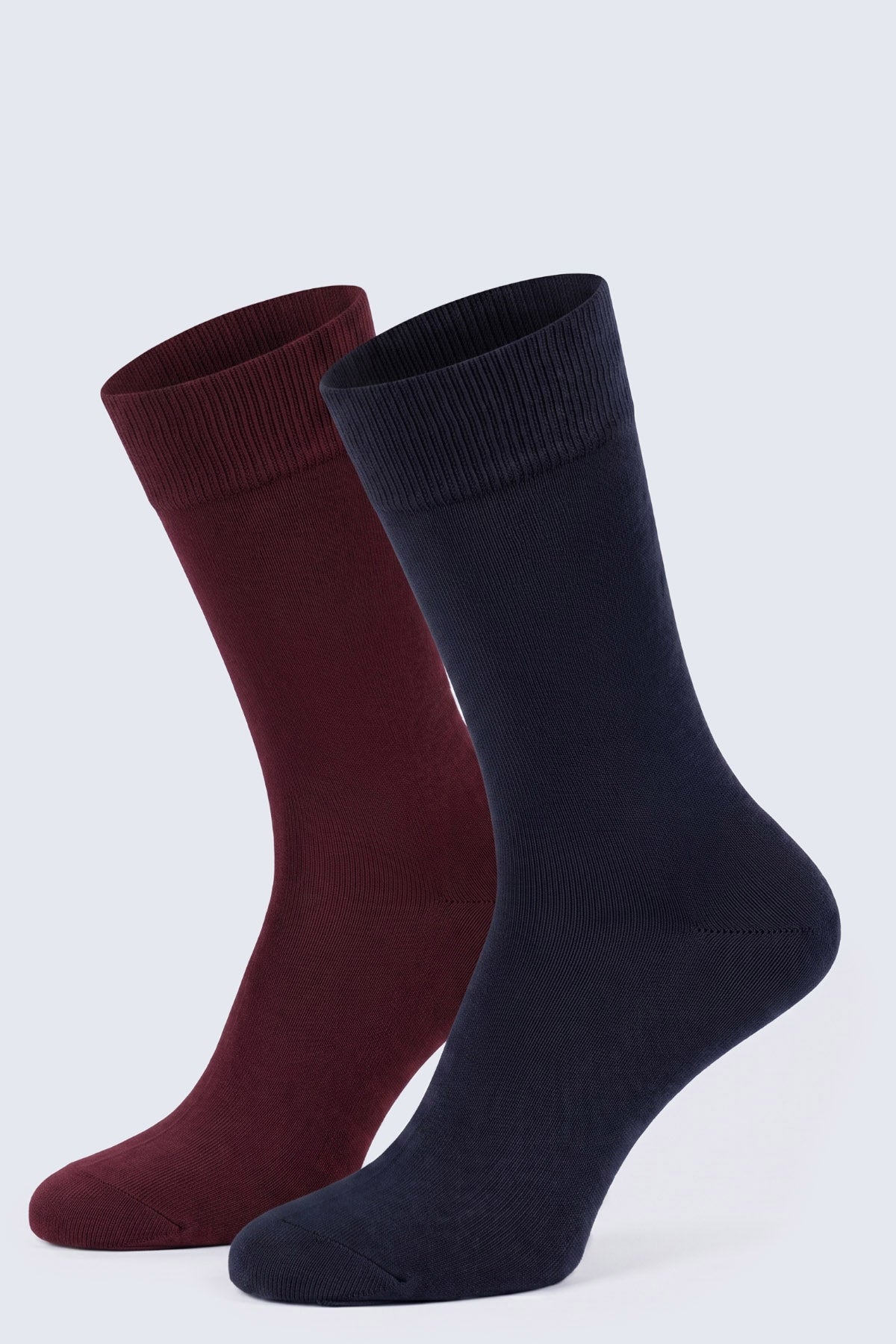 A pair of navy and burgundy socket cotton socks made from soft knit fabric with ribbed cuffs