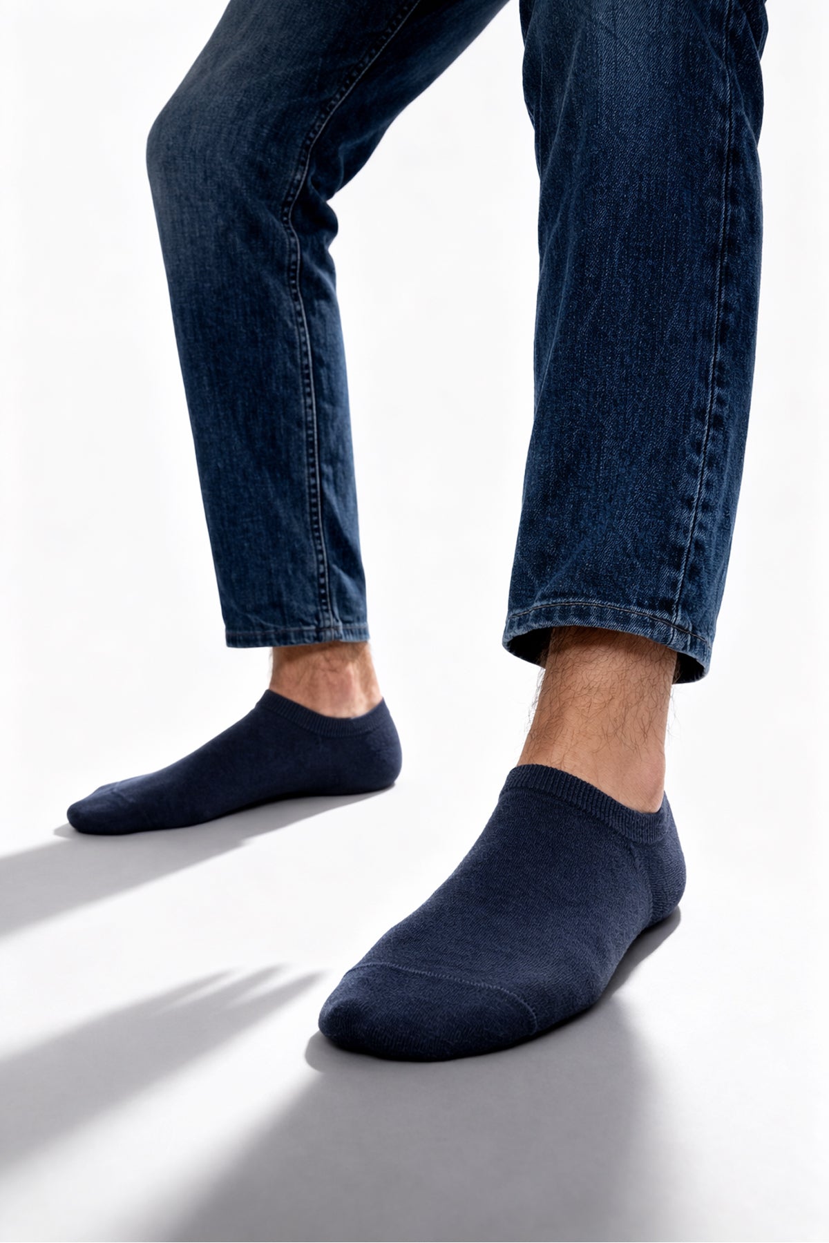 Dark blue no show bamboo socks worn with jeans showing comfortable low cut fit in a 5 pack set