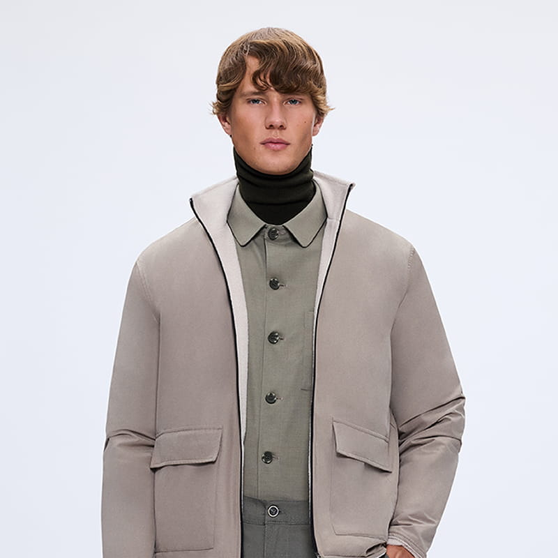 Man wearing taupe jacket layered with shirt and turtleneck, modern smart casual gift look