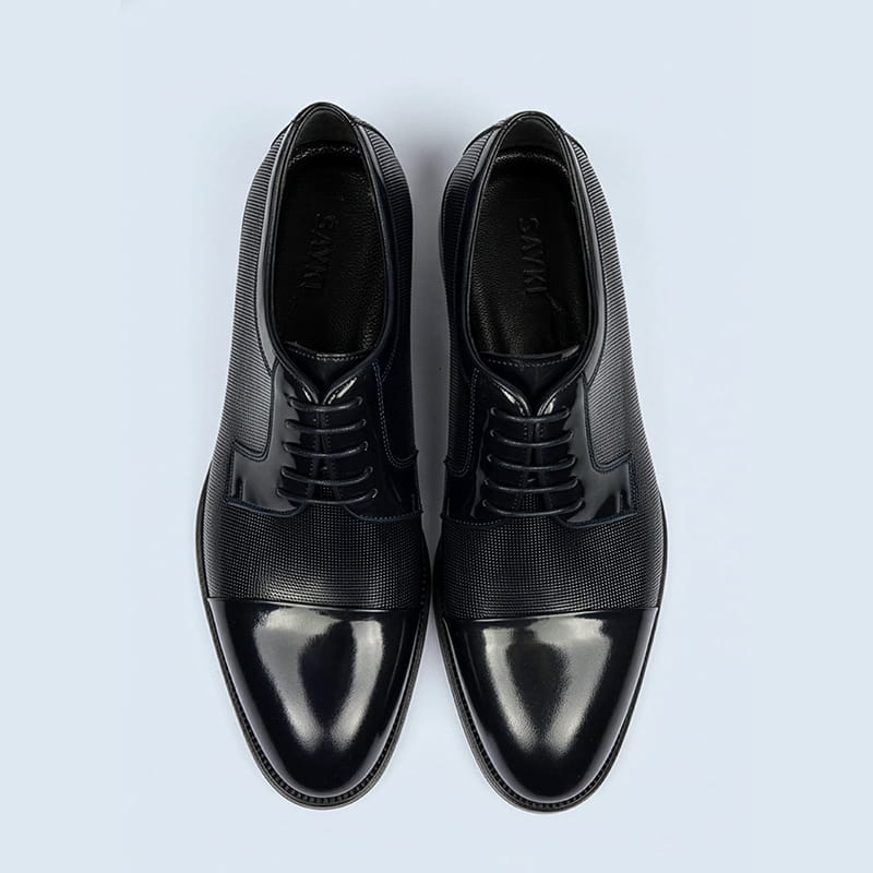 Black leather dress shoes viewed from top, footwear gift category