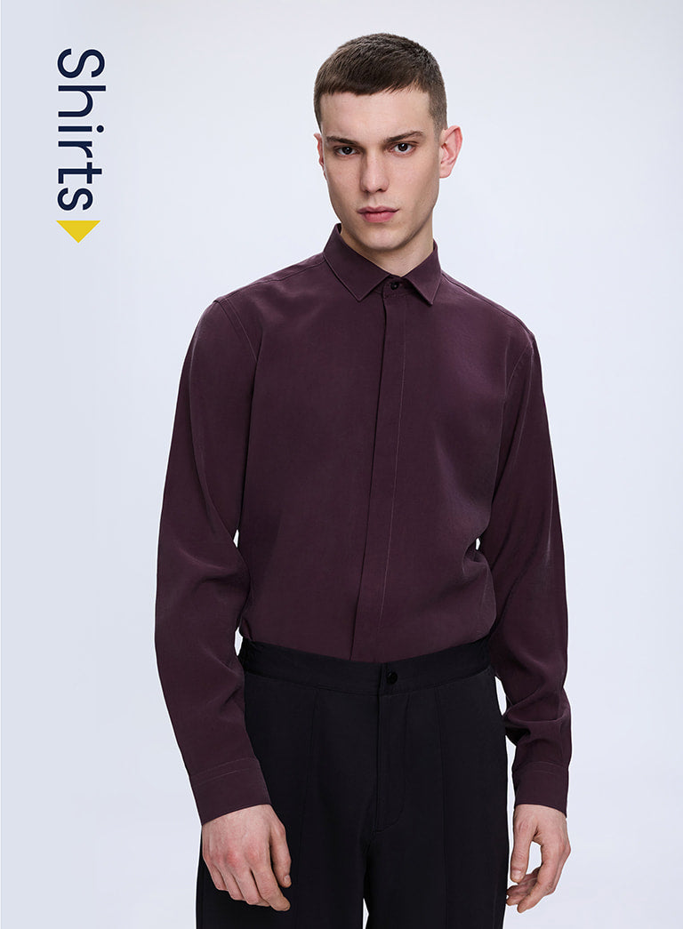 Man wearing a maroon shirt on a white background with 'Shirts' text.