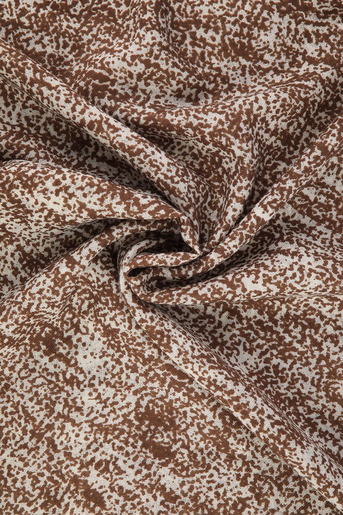 Brown and cream speckled fabric with a soft, flowing texture.