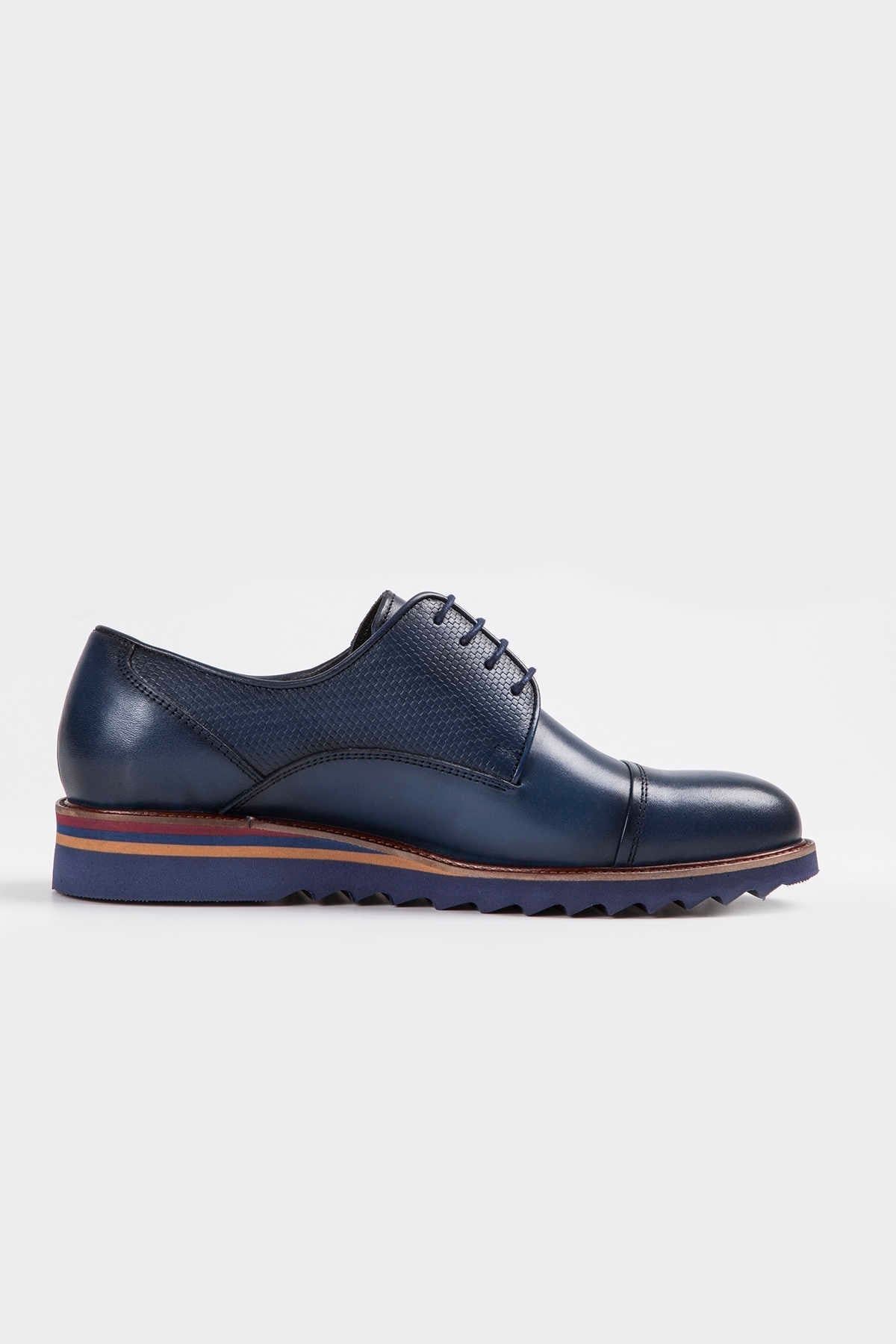 Navy blue leather lace-up oxford shoe with a textured toe cap and multi-toned sole