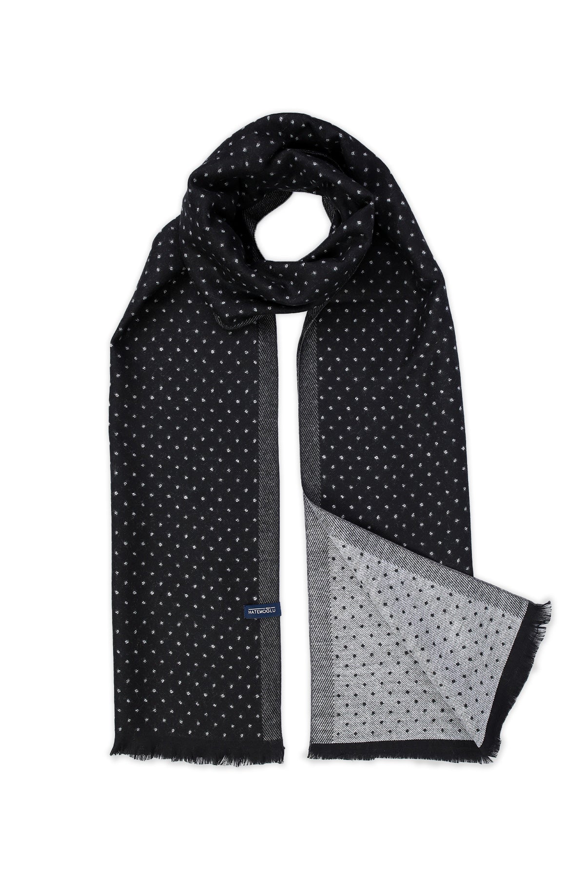 Black scarf with a subtle white polka dot pattern and frayed edges, featuring a contrasting gray textured border.