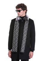Black coat with a silver and gray patterned scarf featuring an ornate, leaf-like design.