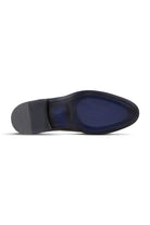 Black leather men’s dress shoe with a navy blue textured insole and rubber heel.