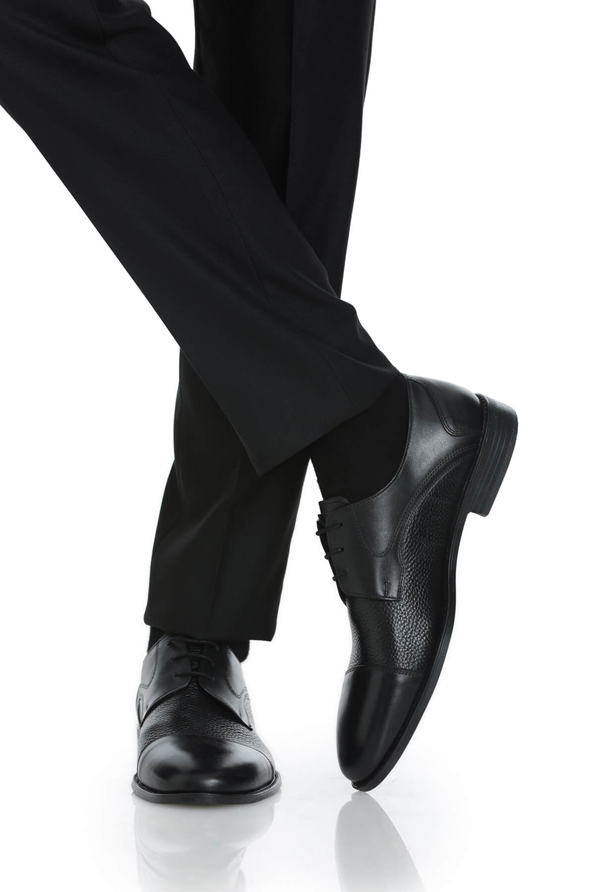 Black leather dress shoes with a textured toe cap and polished finish.