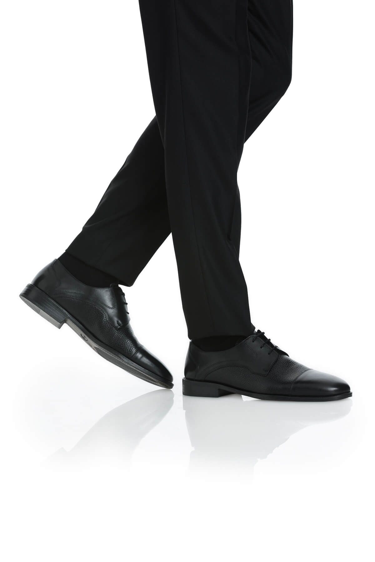 Black leather dress shoes with a polished finish and subtle perforated detailing on the toe cap.