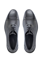 Black leather oxford shoes with a glossy toe cap and textured side panels.