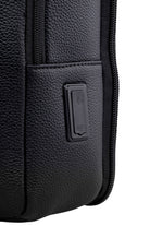 Black textured leather backpack with a built-in usb charging port.