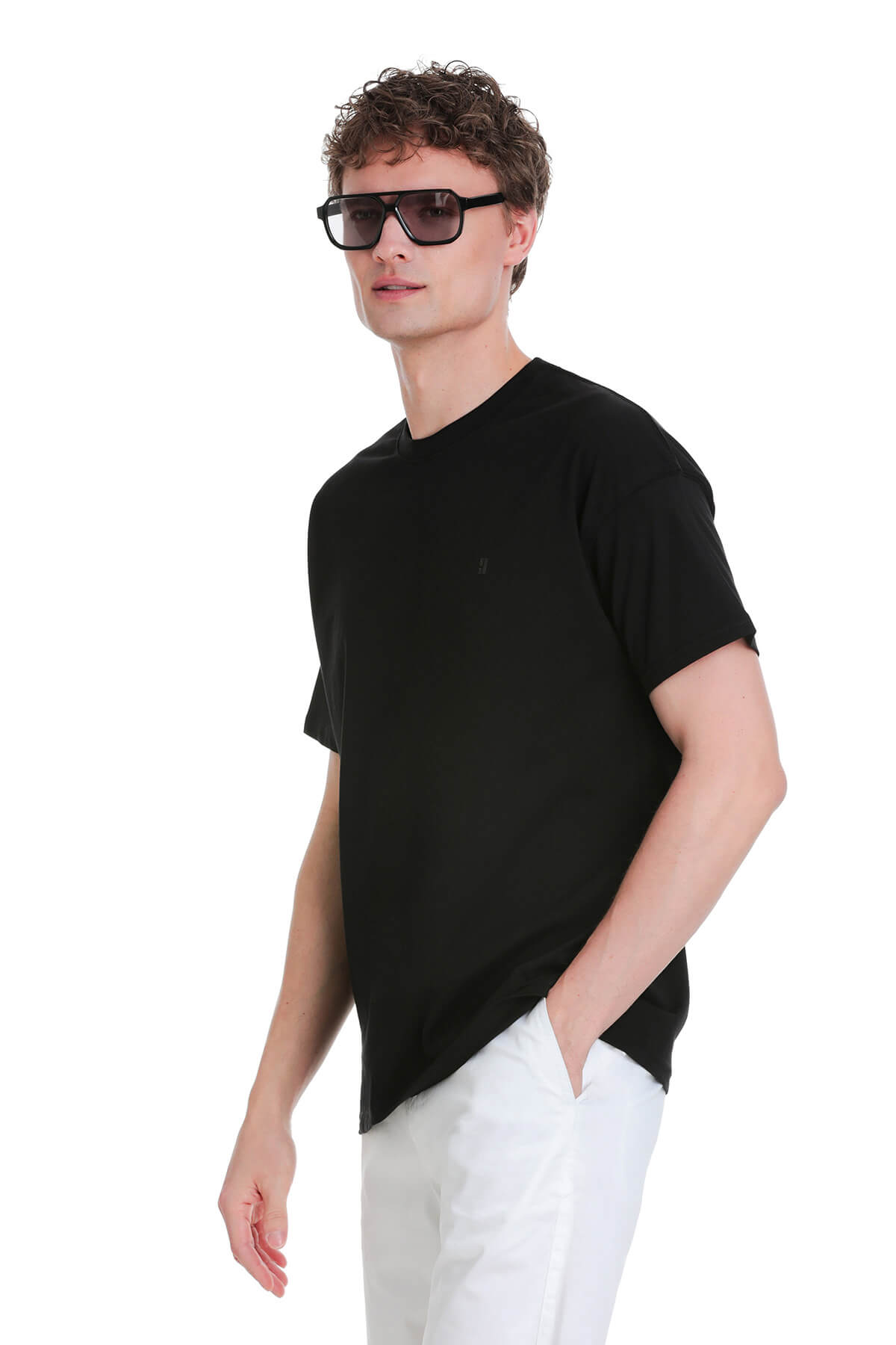 Black oversize crew neck t-shirt with short sleeves and subtle embroidered logo on left chest