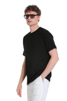 Black oversize crew neck t-shirt with short sleeves and subtle embroidered logo on left chest