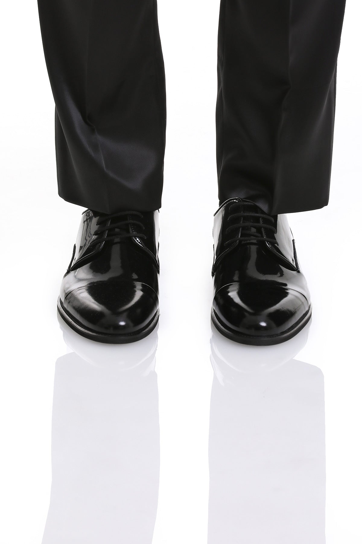 Black patent leather dress shoes with a glossy finish and classic lace-up design.