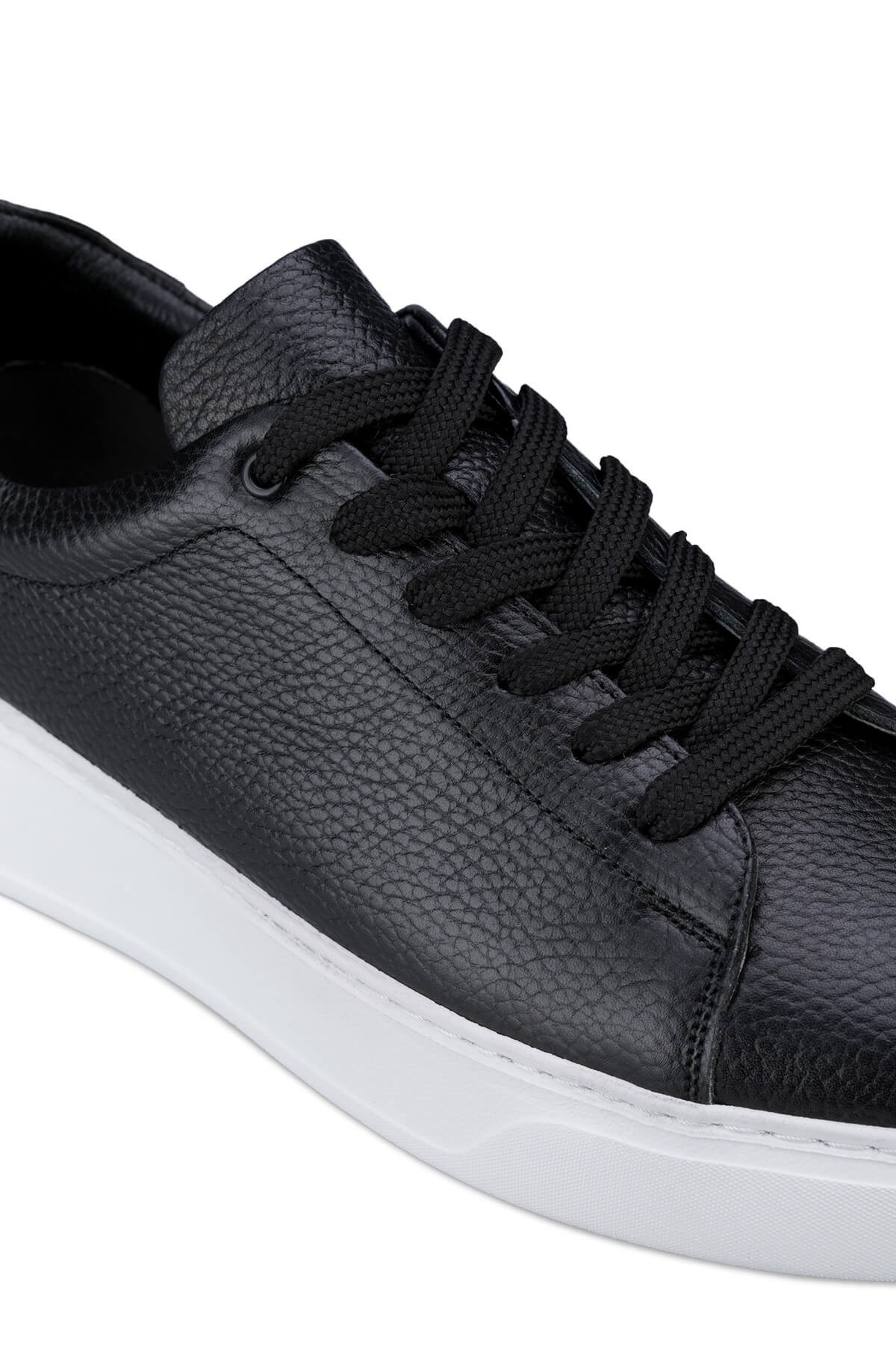 Black textured leather low-top sneaker with a white rubber sole.