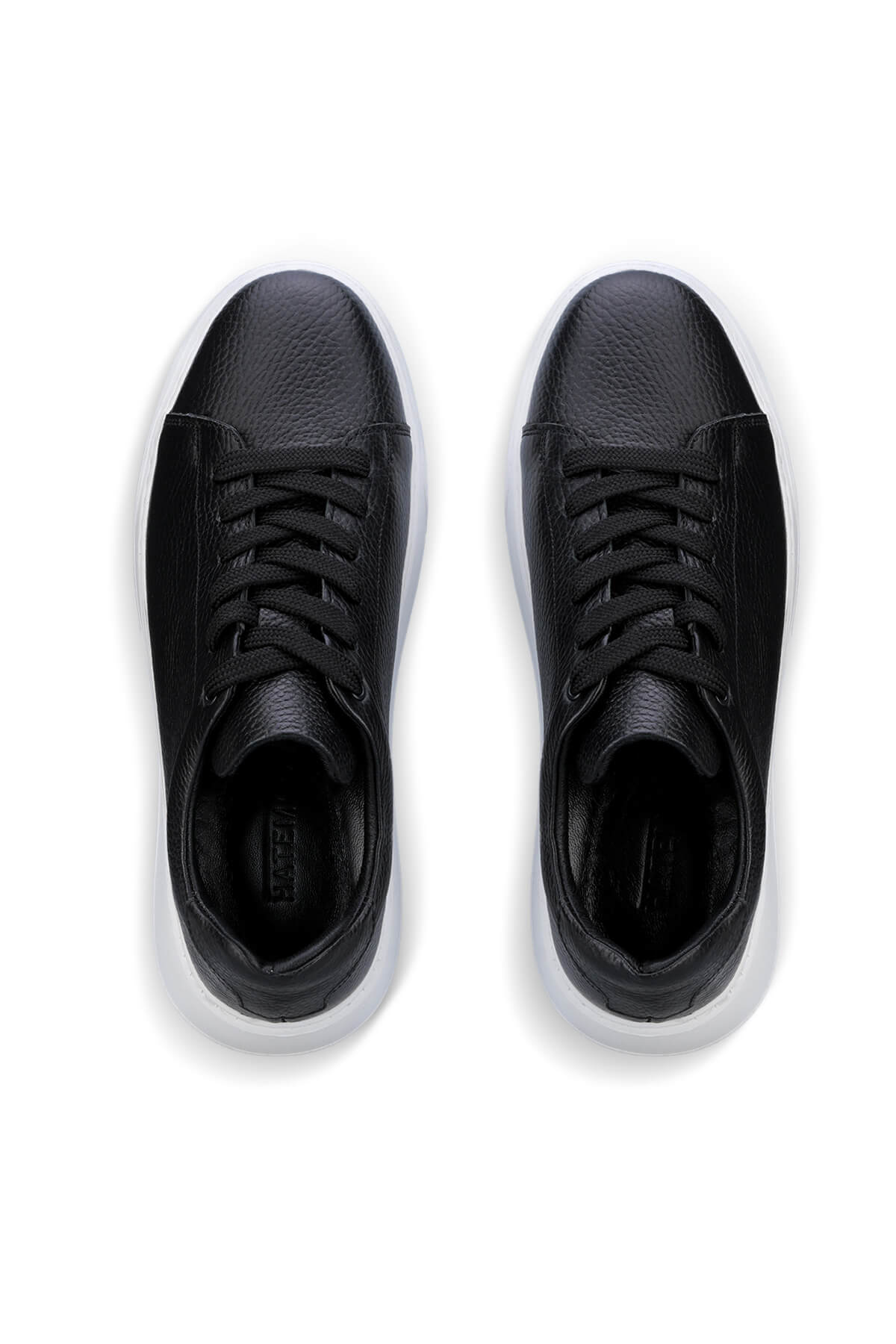 Black leather sneakers with a sleek, minimalist design and white rubber soles.