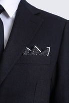 Black polka dot pocket square with white border neatly folded in dark suit breast pocket for smart casual wear