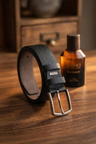 Black sport faux leather belt with silver-toned buckle and subtle pebbled texture for a sleek look
