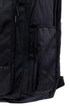 Black nylon backpack with multiple zippered compartments and a sleek, minimalist design.