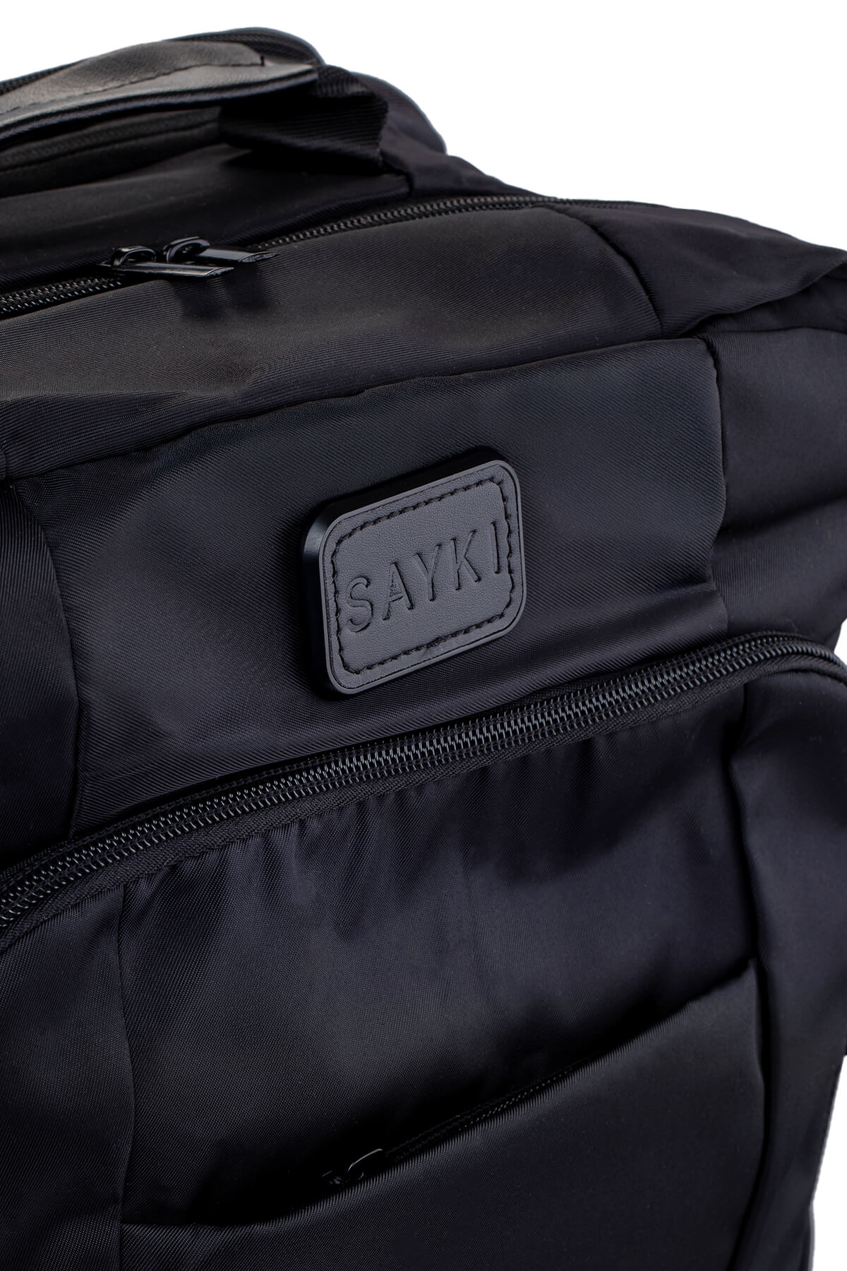 Black sayki backpack with quilted fabric and a leather-like brand patch.