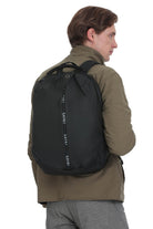 Black sakki backpack with a sleek, modern design and vertical branding along the zipper pull.