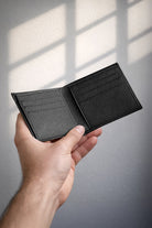 Black wallet made of 100 percent genuine leather with textured surface and multiple card slots for everyday use