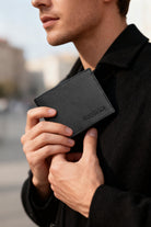 Black textured leather wallet with subtle embossed branding made from genuine leather black for everyday use
