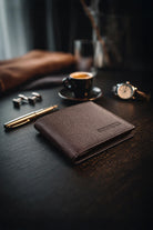 Brown wallet made of genuine leather brown with textured surface and embossed brand name for everyday use